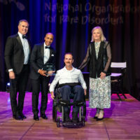 Host Peter Alexander, Rachid Izzar of Biogen, patient presenter Chris Meyer, and NORD CEO Pamela Gavin